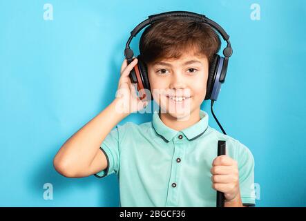 Positive kleine gemischte Rasse Junge trägt Kopfhörer mit exam.audiometry Test hören Stockfoto