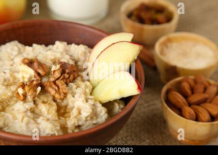 Leckere Haferflocken mit Nüssen und Äpfeln auf dem Tisch aus nächster Nähe Stockfoto