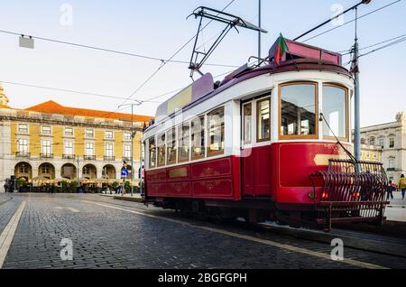 Die traditionelle alte rote Straßenbahn-Seilbahn hält in Praca do Comercio, dem Hauptplatz des Stadtteils Baixa in Lissabon, Portugal Stockfoto