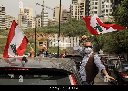 Beirut, Libanon, 21. April 2020. Hunderte von Menschen versammelten sich auf dem Martyrs Square, bevor sie in Beirut herumfuhren und Flaggen schwenkten und aus Protest gegen die Korruption ihrer Regierung und das Versagen, angemessene Dienstleistungen zu erbringen oder den wirtschaftlichen Zusammenbruch des finanziell belasteten Landes zu bewältigen, sangen. Elizabeth Fitt Credit: Elizabeth Fitt/Alamy Live News Stockfoto