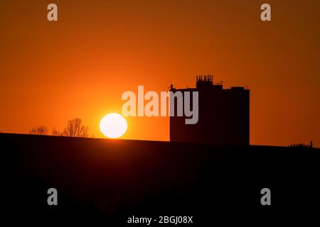 Als die Sperrung aufgrund der Coronavirus-Pandemie in die fünfte Woche einzieht, geht die Sonne angesichts des Wohnblocks Humphries Houes in Brownhills, Walsall, in den West Midlands, Großbritannien, unter. Stockfoto