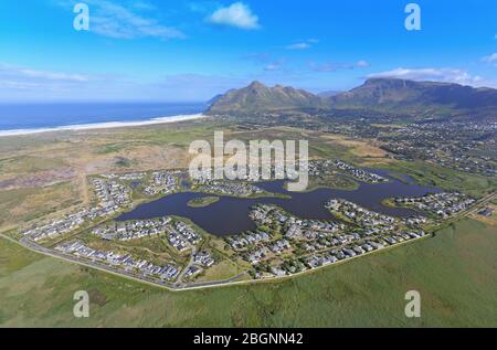 Luftaufnahme der Lake Michelle Entwicklung mit Chapman's Peak und Noordhoek Beach im Hintergrund Stockfoto