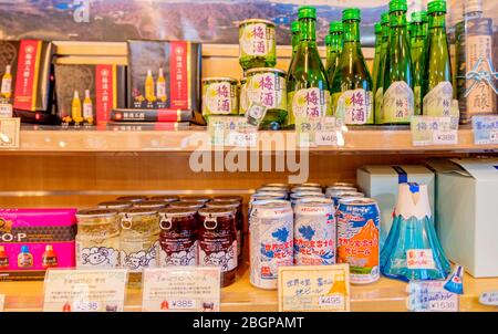 Lokaler japanischer Sake in grünen Flaschen in Regalen in der Herb Hall am See Kawaguchiko, Tokio, Japan 9. Februar 2020 Stockfoto