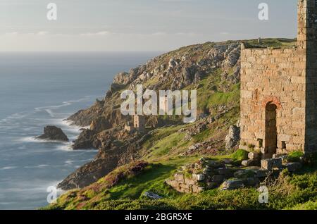 Wheal Edward Mine im Vordergrund mit den Crown Mines, Botallack im Hintergrund mit sanftem Abendlicht, das die Küstenszene in Cornwall unterstreicht Stockfoto