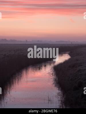 Start des Tages in der Abtei St. Benet. Rosa Sonnenaufgang über dem Bach i - St. benet's Abbey, Februar 2018 Stockfoto