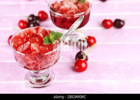 Nahaufnahme von Kirsche Granita in Glasschalen, auf farbigen Holzhintergrund Stockfoto