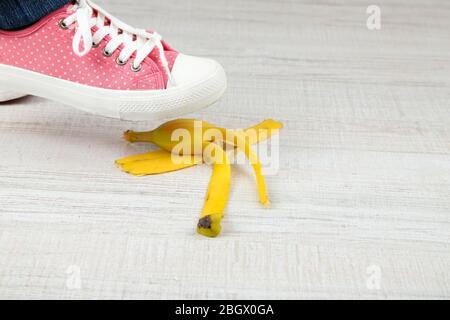 Schuh, um auf Bananenschale zu rutschen und einen Unfall zu haben Stockfoto