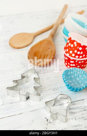 Küchenformen zum Backen auf farbigen Holzhintergrund Stockfoto