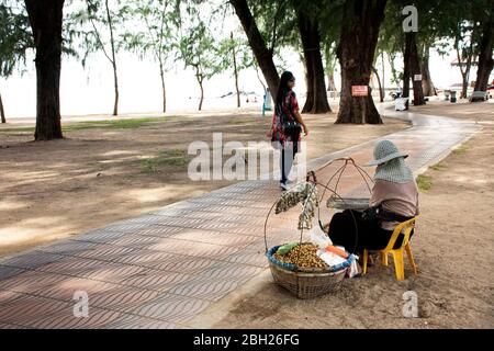 SONGKLA, THAILAND - AUGUST 17 : Alte thai Frau Menschen Verkäufer mit Hawker Korb sitzenden Verkauf Essen und Snack für Reisende auf der Straße Fußweg von Sam Stockfoto