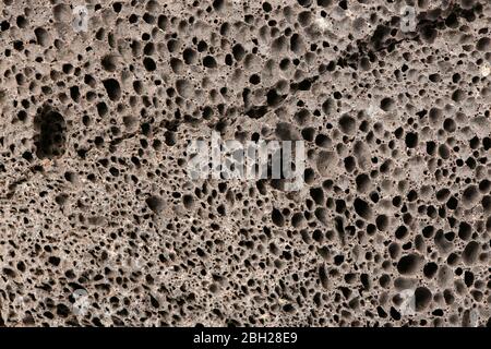 Oberfläche aus braunem Bimsstein - Nahaufnahme. Pümice braune Schwammtextur für Körperwäsche. Hochauflösendes Foto. Volle Schärfentiefe. Stockfoto