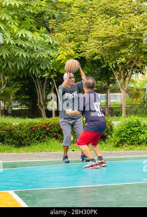 Alter Mann glücklich mit Übung Basketball spielen in BangYai Park Nonthaburi in Thailand. 22. August 2018 Stockfoto