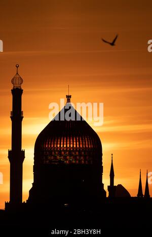 Dresden, Deutschland. April 2020. Die Sonne geht hinter der ehemaligen Dresdner Zigarettenfabrik Jenidze unter, die 1909 im Stil einer 62 Meter hohen Moschee errichtet wurde. Quelle: Sebastian Kahnert/dpa-Zentralbild/dpa/Alamy Live News Stockfoto