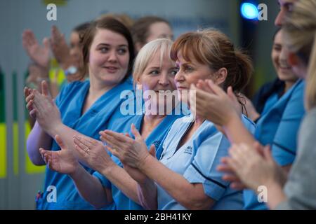Glasgow, Großbritannien. April 2020. Im Bild: NHS-Mitarbeiter und Nothelfer zeigen ihre Wertschätzung während der Kampagne "Clap for our carers" - eine wöchentliche Hommage an NHS und Schlüsselarbeiter während des Ausbruch des Coronavirus (COVID-19). Die Öffentlichkeit wird ermutigt, jeden Donnerstag um 20 Uhr NHS-Mitarbeiter und andere wichtige Arbeitnehmer aus ihren Häusern zu begrüßen. Bis heute hat die Coronavirus (COVID-19) Pandemie weltweit über 2.6 Millionen Menschen infiziert, und in Großbritannien 138,078 infiziert und 18,738 getötet. Quelle: Colin Fisher/Alamy Live News Stockfoto