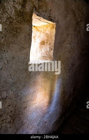 Festung Tunnel Nahaufnahme von kleinen Fenster in dunklen Weg Passage in Castiglione del Lago in Italien mit Schatten in historischen Dorf Festung Stockfoto