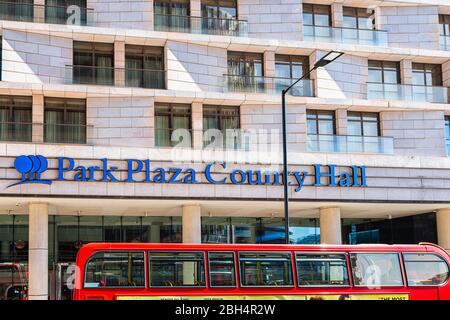 London, Großbritannien - 22. Juni 2018: Blaues Schild für das Park plaza County Hall Hotel an der Straße und dem roten Bus Stockfoto