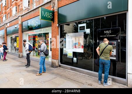 London, Großbritannien - 23. Juni 2018: Royal Borough of Chelsea Street und Außenansicht des Gebäudes und Menschen Bürgersteig Schild für Marks und Spencers Geschäft und geldautomaten Stockfoto