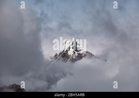 Matschaputschare Fisch Geschichte Peak durch Wolken im Himalaya, Nepal umgeben. Stockfoto