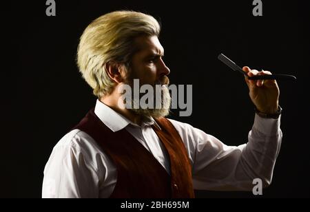 Friseurschere. Friseur. Blonde Friseur oder Friseur mit Schere. Hipster man Friseur. Guy Friseur schneidet Haare mit Schere. Männlich Schönheitssalon. Machen Haarschnitt perfekt aussehen. Stockfoto