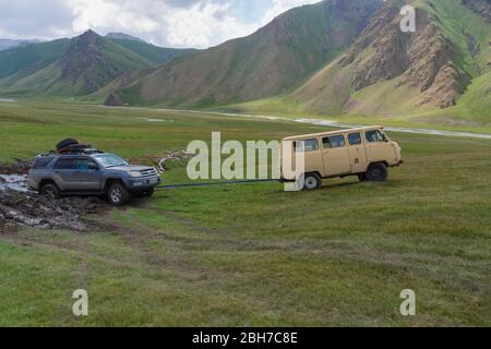 Ziehen Sie einen festgefahrenen Auto, Kurumduk Tal, Provinz Naryn, Kirgisistan, Zentralasien Stockfoto