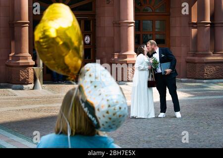 Dortmund, 24. April 2020: Hochzeit in Corona Times. Ein Paar heiratete am 24. April. Vor dem Standesamt gratulierten Familienangehörige und Freunde ihnen im angemessenen Sicherheitsabstand. Stockfoto