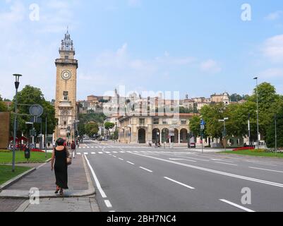 Bergamo, Italien - 06. August 2019: Menschen, die auf den Straßen im unteren Teil der Stadt Bergamo mit Blick auf die befestigte Oberstadt im Hinterland spazieren Stockfoto