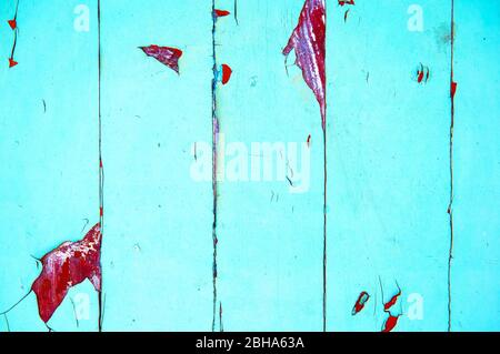 Alte Holztafel in grün und rot mit Kratzern und Spänen bemalt. Stockfoto