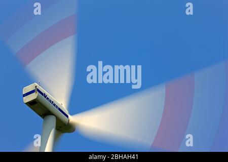 Windturbinengenerator wird gegen blauen Himmel betrieben Stockfoto