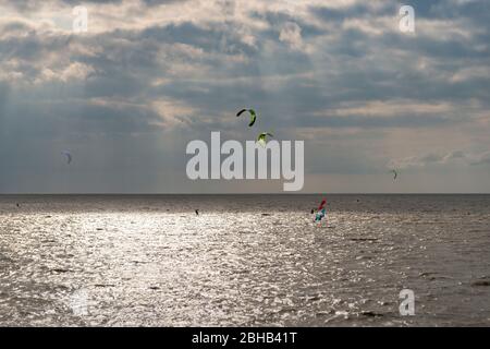 Deutschland, Niedersachsen, Ostfriesland, Norddeich, Kitesurfer vor Norddeich. Stockfoto