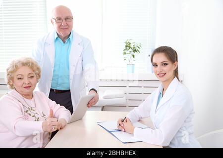 Glückliche Ärzte und Patienten in der Klinik Stockfoto