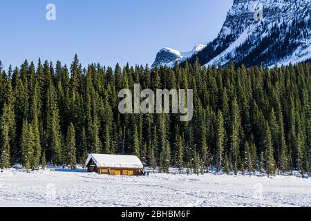 LAKE LOUISE, KANADA - 20. MÄRZ 2020: Felsige Berge rund um den gefrorenen Lake louise Winterwunderland. Stockfoto