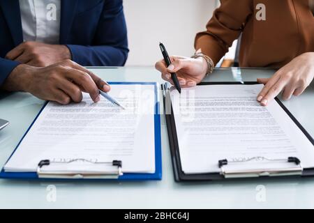 In der Nähe von zwei Geschäftsleute Arbeiten auf Papier über Schreibtisch Stockfoto