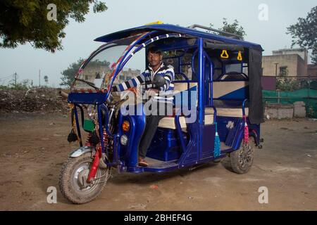 Indischer E-Rikscha-Fahrer mit seiner E-Rikscha, Indien Stockfoto