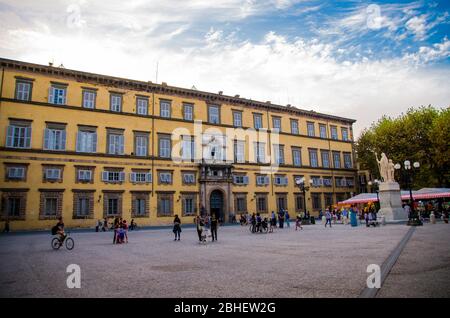 Lucca, Italien, 13. September 2018: Die Leute laufen und spielen mit kleinen Kindern auf Piazza Napoleone Platz in der Nähe Palazzo Ducale Palast im historischen Zentrum der mittelalterlichen Stadt Lucca, Toskana Stockfoto