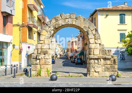 Rimini, Italien, 19. September 2018: Ruinen des alten Steinbogens Porta Montanara Tor zwischen traditionellen typischen italienischen Gebäuden auf der Straße in alten historischen touristischen Stadtzentrum, Emilia-Romagna Stockfoto