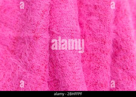 Muster aus rosa Strickpullover Closeup. Handgefertigtes Merinowolle Produkt. Ein Stapel gefalteter Kleidung Stockfoto