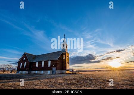 Sonnenuntergang über der verlassenen St. Joseph Parish Catholic Church in Frenchville, Saskatchewan Stockfoto