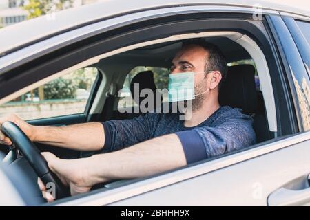 Mann trägt Schutzmaske, um die Infektion von Viren und verschmutzte Luft Ausbreitung Krankheiten in seinem Auto zu vermeiden. Gesundheitswesen, Coronavirus, Influenza Stockfoto