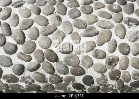 Textur Hintergrund-eine Wand aus runden alten Stein. Grau monochrome Tonung. Stockfoto