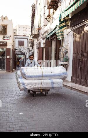 Jeddah / Saudi Arabien - 16. Januar 2020: Immigrant schiebt einen Wagen im historischen Al-Balad Stockfoto