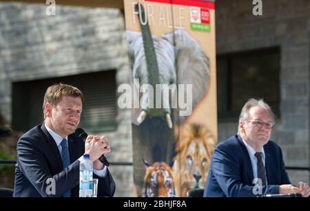 26. April 2020, Sachsen-Anhalt, Halle (Saale): Ministerpräsident Michael Kretschmer (CDU, l.) und Ministerpräsident Reiner Haseloff (CDU) von Sachsen-Anhalt bei einer Pressekonferenz im Bergzoo Halle/Saale vor einem Plakat mit Elefant, Löwe und Tiger. Zuvor hatten die beiden Regierungschefs die weitere Vorgehensweise im Umgang mit der Pandemie von Corona diskutiert. Die beiden Regierungschefs hatten zuvor über die weitere Vorgehensweise im Umgang mit der Corona-Pandemie diskutiert und gesagt, sie sollten gemeinsam abwägen, welche weitere Entspannung und Möglichkeiten sich eröffnen Stockfoto