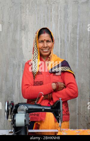 Selbstbewusste Frau mit Nähmaschine im ländlichen Indien Stockfoto