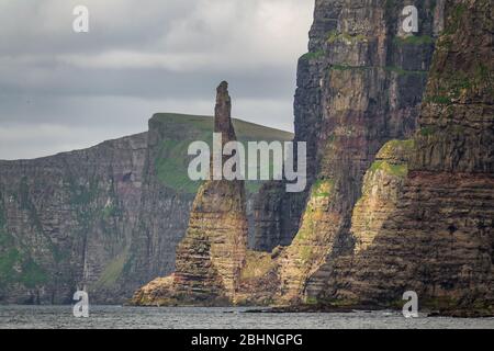 Nadelfelsen in der steilen Küste der Färöer Inseln Stockfoto