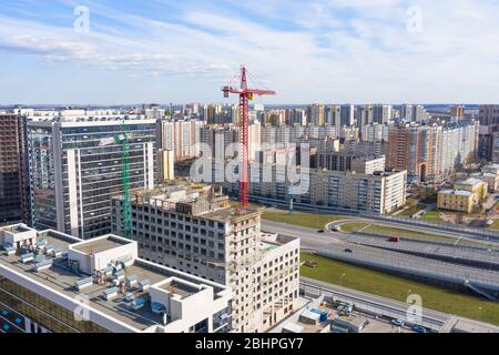 Luftaufnahme der Glasgebäude mit Wohnungen, einem Gebäudekomplex im Bau und einem Wohngebiet von mehrstöckigen Gebäuden i Stockfoto