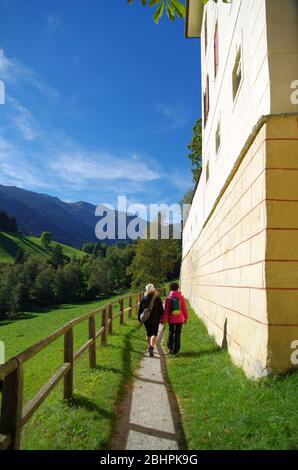 Zwei junge Wanderinnen wandern fröhlich auf Bergwegen und bewundern die Aussicht während ihres Urlaubs Stockfoto
