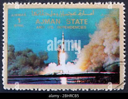 AJMAN - UM 1973: Eine im Ajman gedruckte Marke zeigt den Raketenstart Saturn V., Mondlandung, Apollo 11, um 1973 Stockfoto