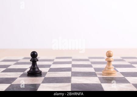 Nahaufnahme der Seite des Schachbretts mit schwarzem Bauern mit Blick auf weißen Bauern Stockfoto
