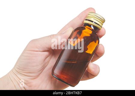 Hand mit kleiner Flasche auf weißem Hintergrund isoliert. Nahaufnahme Stockfoto