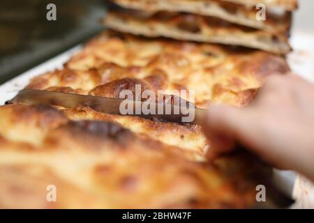 Schneiden knusprige Focaccia in Rom Italien Stockfoto