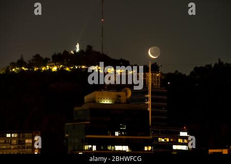 Malerische Aussicht auf San Cristobal in Santiago de Chile während eines kleinen, wachenden Halbmonds. Idyllische Aussicht mit dem kleinen Mond erhellend Stockfoto