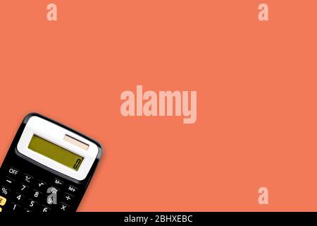 Rechner auf orangefarbenem Hintergrund. Business- und Copy Space-Konzept Stockfoto